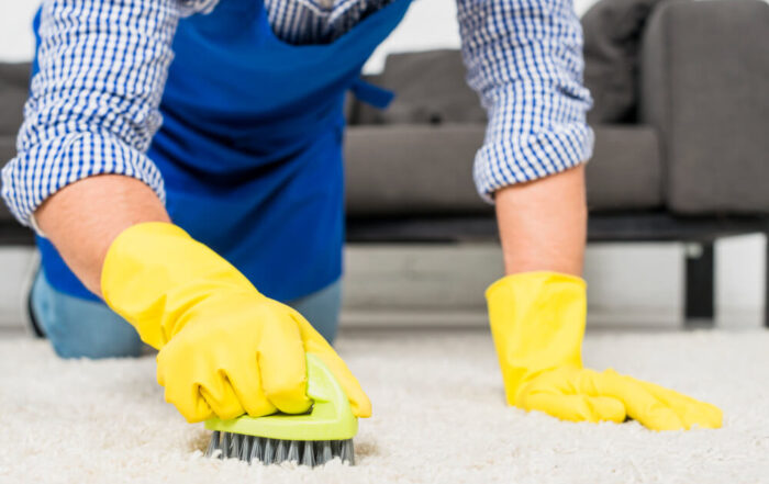 close up man cleaning his house