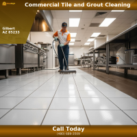 A professional Citrus Bright technician deep cleans large ceramic tile floors inside a commercial restaurant kitchen using specialized tile and grout cleaning equipment. The bright, restored tile surface and clean grout lines highlight a sanitary, professional environment for food service facilities.